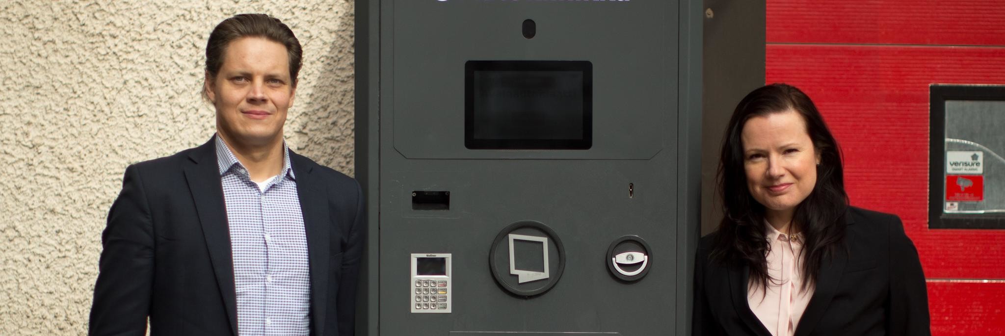 Service Automatics founders beside a self-service machine